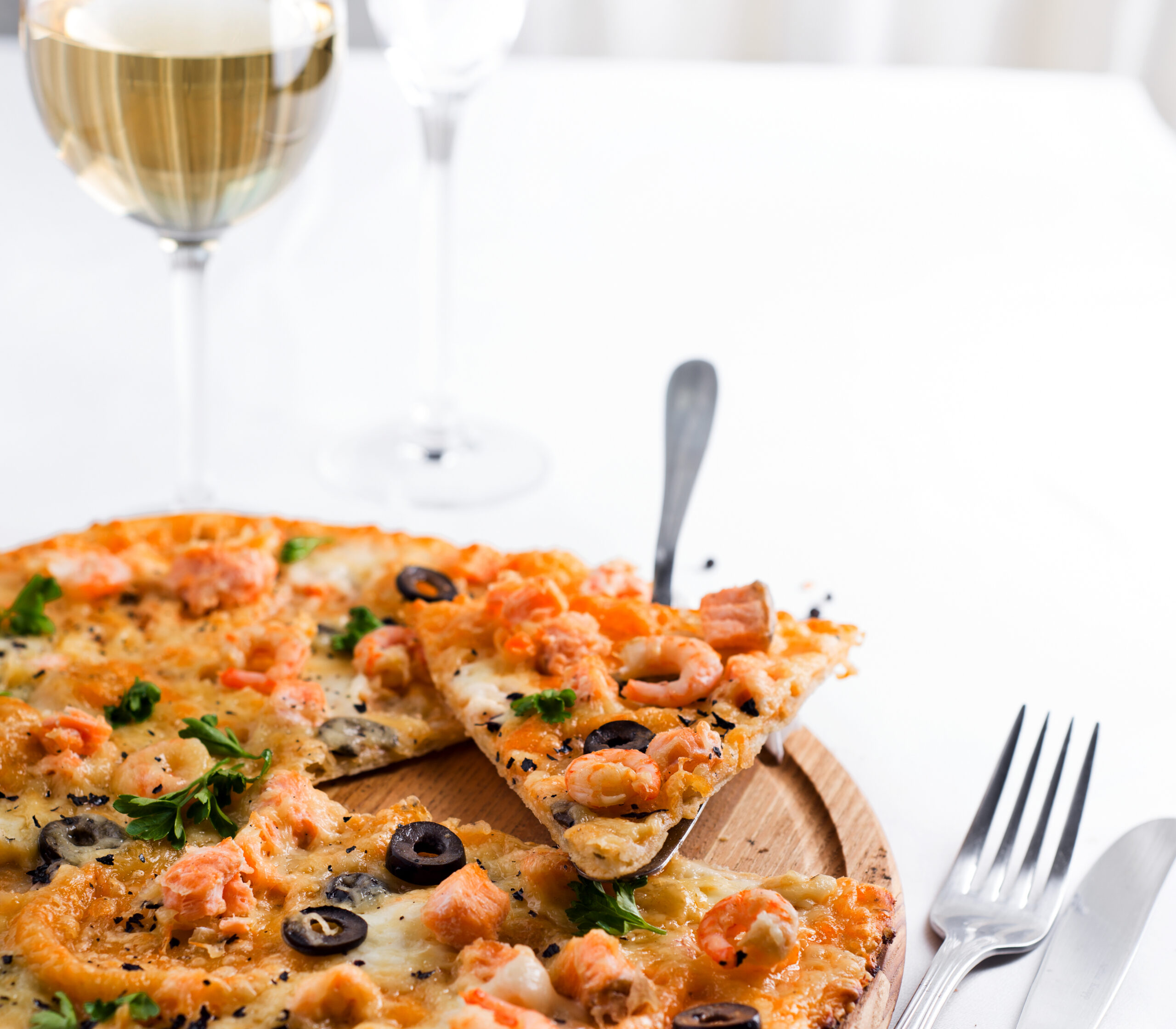 Glass of white wine with shrimp pizza