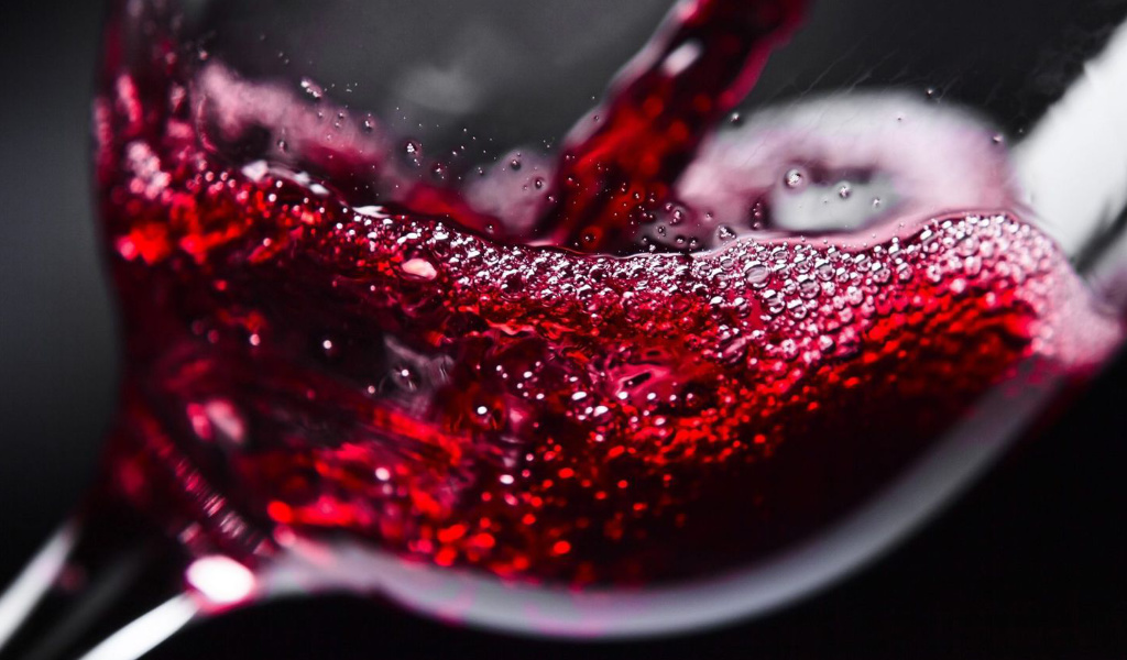 zoomed in view of a glass of red wine